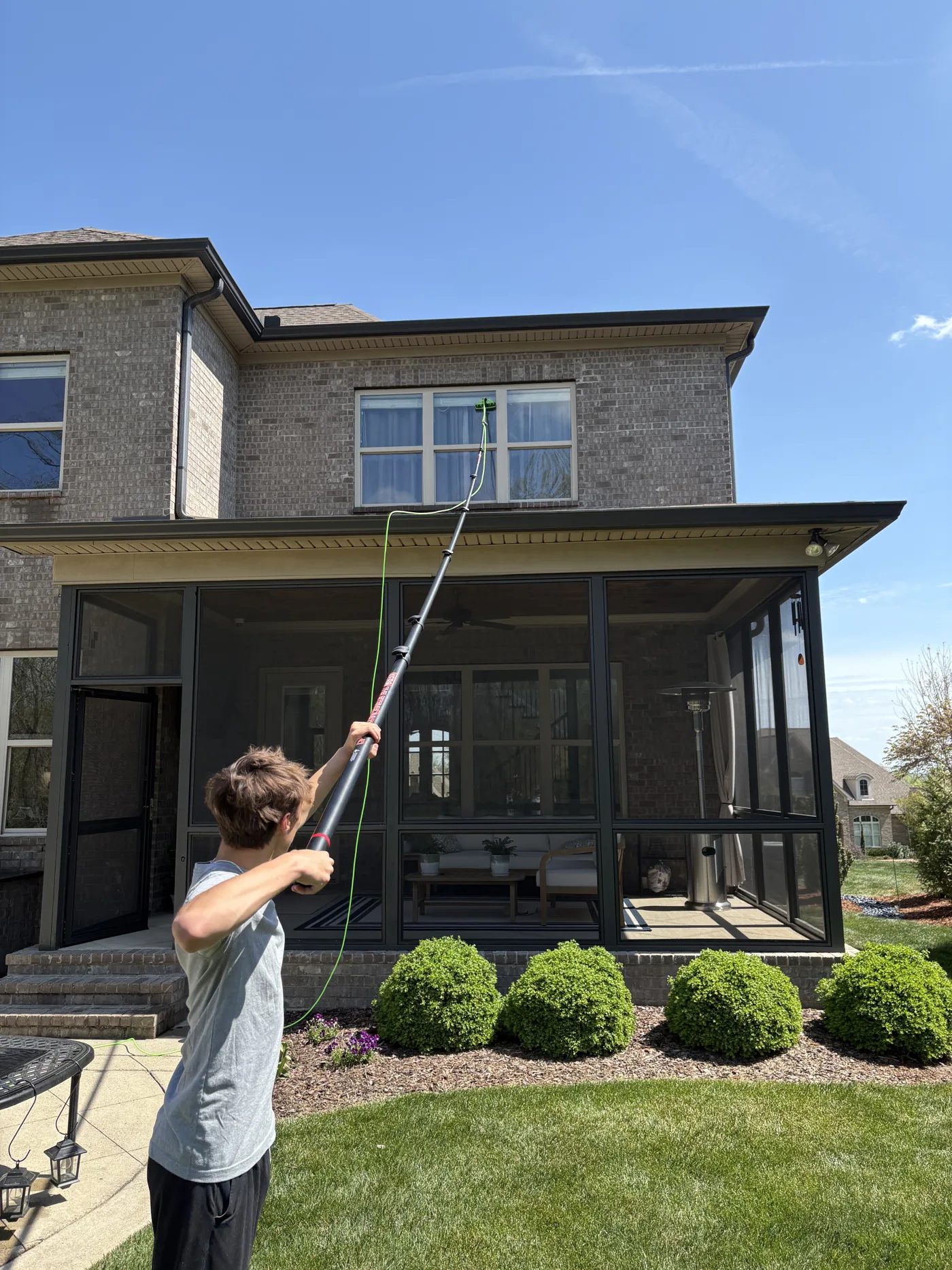 OAK Window Cleaning technician cleaning residential windows in Thousand Oaks
